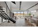 Modern living space with outdoor views, an open staircase and kitchen with bar seating at 3980 Heron Fairway Dr, Las Vegas, NV 89141