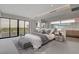 Spacious main bedroom with balcony access, ensuite bathroom and modern furnishings at 3980 Heron Fairway Dr, Las Vegas, NV 89141