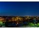 Night view of a serene neighborhood with a calm lake reflecting streetlights at 3980 Heron Fairway Dr, Las Vegas, NV 89141