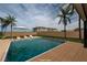 Backyard pool with lounge chairs and palm trees at 3980 Heron Fairway Dr, Las Vegas, NV 89141