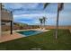 Backyard with a pool, lounge chairs, and palm trees at 3980 Heron Fairway Dr, Las Vegas, NV 89141