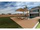 Backyard with a pool, lounge chairs, and outdoor umbrella at 3980 Heron Fairway Dr, Las Vegas, NV 89141