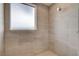 Close-up of the tiled shower with frosted window and modern shower head at 3980 Heron Fairway Dr, Las Vegas, NV 89141