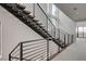 Modern staircase with wooden steps and black metal railings, with upper level landing view at 3980 Heron Fairway Dr, Las Vegas, NV 89141