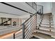 Modern staircase with wooden steps and black metal railings, adjacent to kitchen at 3980 Heron Fairway Dr, Las Vegas, NV 89141