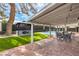 Backyard showcasing well-manicured lawn, covered patio, pool, and gazebo at 3991 Shadow Wood Ave, Las Vegas, NV 89121