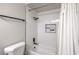 Up close view of a shower and tub, with modern tile, and toiletry containers at 3991 Shadow Wood Ave, Las Vegas, NV 89121