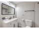 This bathroom features a modern vanity, a toilet, and a shower with white tiling at 3991 Shadow Wood Ave, Las Vegas, NV 89121