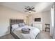Bright bedroom features a ceiling fan, a TV, and a window providing natural light at 3991 Shadow Wood Ave, Las Vegas, NV 89121