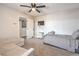 Bedroom with a ceiling fan, window, couch, and a bed at 3991 Shadow Wood Ave, Las Vegas, NV 89121
