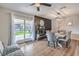 Inviting dining area featuring a brick fireplace and sliding door to the backyard at 3991 Shadow Wood Ave, Las Vegas, NV 89121