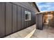 Exterior home detail of siding and window with adjacent storage area at 3991 Shadow Wood Ave, Las Vegas, NV 89121