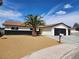 Beautiful single-story home featuring a black garage door, a beautiful palm tree and a well-maintained lawn at 3991 Shadow Wood Ave, Las Vegas, NV 89121