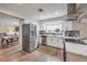 Modern kitchen with stainless steel appliances and a view of the billiards room at 3991 Shadow Wood Ave, Las Vegas, NV 89121