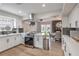 Well-lit kitchen with stainless steel appliances and a view of the dining area at 3991 Shadow Wood Ave, Las Vegas, NV 89121