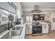 Charming kitchen with stainless steel sink and a view of the dining area at 3991 Shadow Wood Ave, Las Vegas, NV 89121