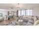 Spacious living room with a large sectional sofa, pool table, and lots of natural light at 3991 Shadow Wood Ave, Las Vegas, NV 89121