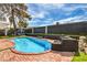 Inviting backyard pool with a diving board, gazebo, and well-maintained landscaping at 3991 Shadow Wood Ave, Las Vegas, NV 89121