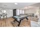 Spacious recreation room with a pool table, comfortable seating, and natural lighting at 3991 Shadow Wood Ave, Las Vegas, NV 89121