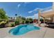 A backyard pool with lounge chairs and desert landscaping at 4129 Fabulous Finches Ave, North Las Vegas, NV 89084
