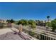 A balcony view overlooking trees and desert landscape in a residential neighborhood at 4129 Fabulous Finches Ave, North Las Vegas, NV 89084