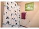 Bright bathroom with a tub-shower featuring a decorative curtain and matching textiles at 4129 Fabulous Finches Ave, North Las Vegas, NV 89084