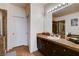 Bathroom featuring granite counters, wood cabinets, and shower with glass door at 4129 Fabulous Finches Ave, North Las Vegas, NV 89084
