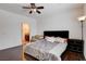 Relaxing bedroom with hardwood floors, ceiling fan, and adjacent sitting area and Primary bath at 4129 Fabulous Finches Ave, North Las Vegas, NV 89084