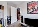 Bedroom with casual seating and doorway to another room; decorated with a movie poster at 4129 Fabulous Finches Ave, North Las Vegas, NV 89084