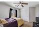 Comfortable bedroom with ceiling fan, carpet, and ample natural light at 4129 Fabulous Finches Ave, North Las Vegas, NV 89084