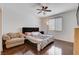 Comfortable bedroom with wood floors, ceiling fan, and large window for natural light at 4129 Fabulous Finches Ave, North Las Vegas, NV 89084