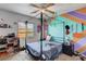 Bright bedroom featuring a four-post bed and ceiling fan at 4129 Fabulous Finches Ave, North Las Vegas, NV 89084