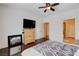 Spacious bedroom offering hardwood floors, dresser with TV, and doorway to the Primary bathroom at 4129 Fabulous Finches Ave, North Las Vegas, NV 89084
