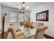Elegant dining room featuring a chandelier, glass table, and seating for eight at 4129 Fabulous Finches Ave, North Las Vegas, NV 89084