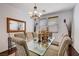 Dining area featuring chandelier, glass table, and seating for eight guests at 4129 Fabulous Finches Ave, North Las Vegas, NV 89084