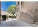 Home's exterior includes a side entrance stairway, landscaping, and a stucco and stone exterior at 4129 Fabulous Finches Ave, North Las Vegas, NV 89084