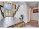 Grand foyer boasting a soaring ceiling, elegant staircase, tiled floor and decorative chandelier at 4129 Fabulous Finches Ave, North Las Vegas, NV 89084