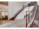 Spacious entryway with dual curved staircase, hardwood steps, tile flooring, and views into the adjacent dining room at 4129 Fabulous Finches Ave, North Las Vegas, NV 89084
