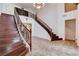 Beautiful home entry featuring a dual staircase, wood handrails, and tile flooring at 4129 Fabulous Finches Ave, North Las Vegas, NV 89084