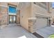 Home's exterior features a beautiful double door entry, a three-car garage and stone accents at 4129 Fabulous Finches Ave, North Las Vegas, NV 89084