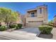 A beautiful two-story home that features a three-car garage, landscaping, and stucco and stone exterior at 4129 Fabulous Finches Ave, North Las Vegas, NV 89084