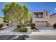 Charming two-story home featuring stone accents, mature landscaping, and a convenient three-car garage at 4129 Fabulous Finches Ave, North Las Vegas, NV 89084