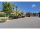 Community entrance gate and landscaped median with mature trees and shrubs at 4129 Fabulous Finches Ave, North Las Vegas, NV 89084