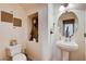 Neat half bathroom featuring a pedestal sink, decorative niche, and modern fixtures at 4129 Fabulous Finches Ave, North Las Vegas, NV 89084