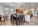 Kitchen and dining area featuring modern lighting, cabinetry, and tile flooring at 4129 Fabulous Finches Ave, North Las Vegas, NV 89084
