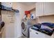 Functional laundry room with modern machines and storage; decorated with a cute laundry sign at 4129 Fabulous Finches Ave, North Las Vegas, NV 89084