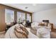 Relaxing living room with curved sofas, ottoman and a bar for entertaining guests in style at 4129 Fabulous Finches Ave, North Las Vegas, NV 89084