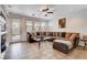 Comfortable living room features tile floors, ceiling fan, recessed lights, and multiple windows at 4129 Fabulous Finches Ave, North Las Vegas, NV 89084
