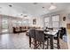 Open-concept living room with tile floors, a dining area and a large sofa at 4129 Fabulous Finches Ave, North Las Vegas, NV 89084
