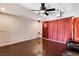 Cozy living room featuring hardwood floors, ceiling fan, and home theater projector at 4129 Fabulous Finches Ave, North Las Vegas, NV 89084